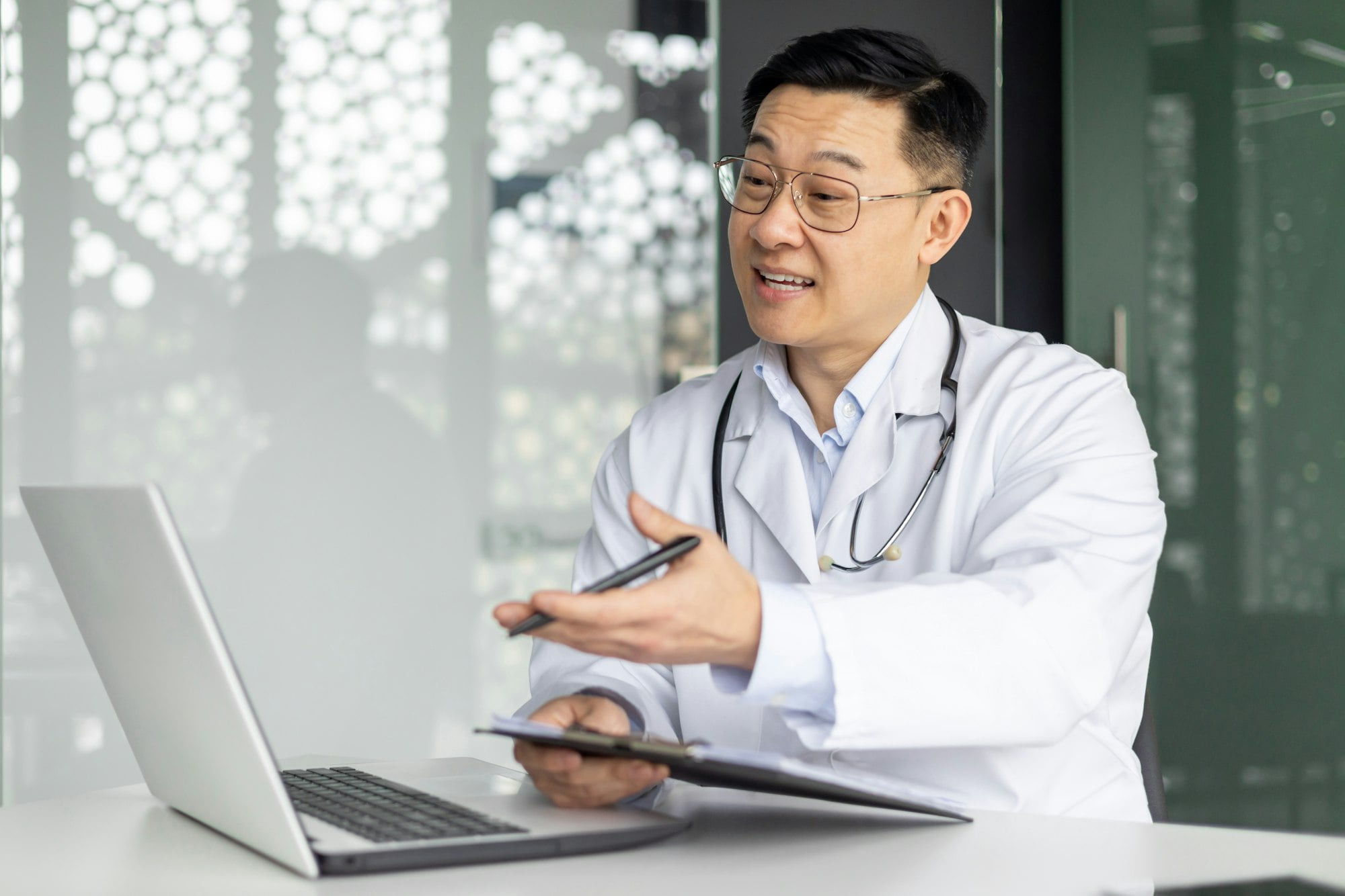Asian doctor discussing healthcare with patient online