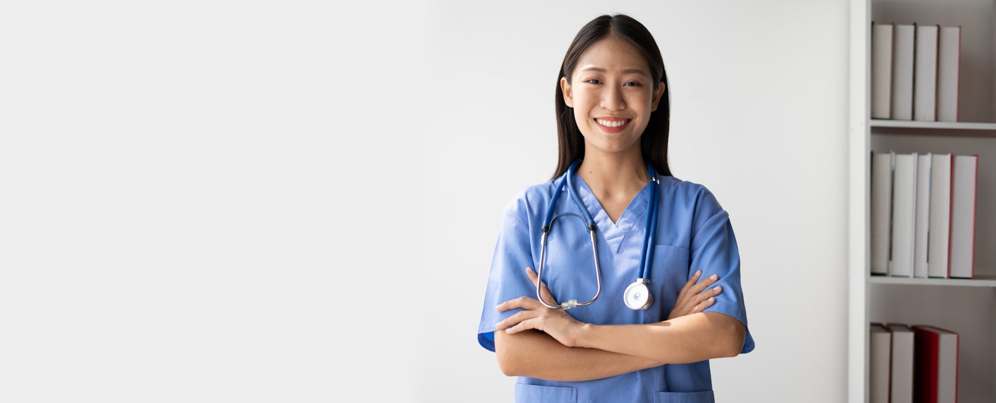 Portrait of female asian doctor standing in her office at clinic.