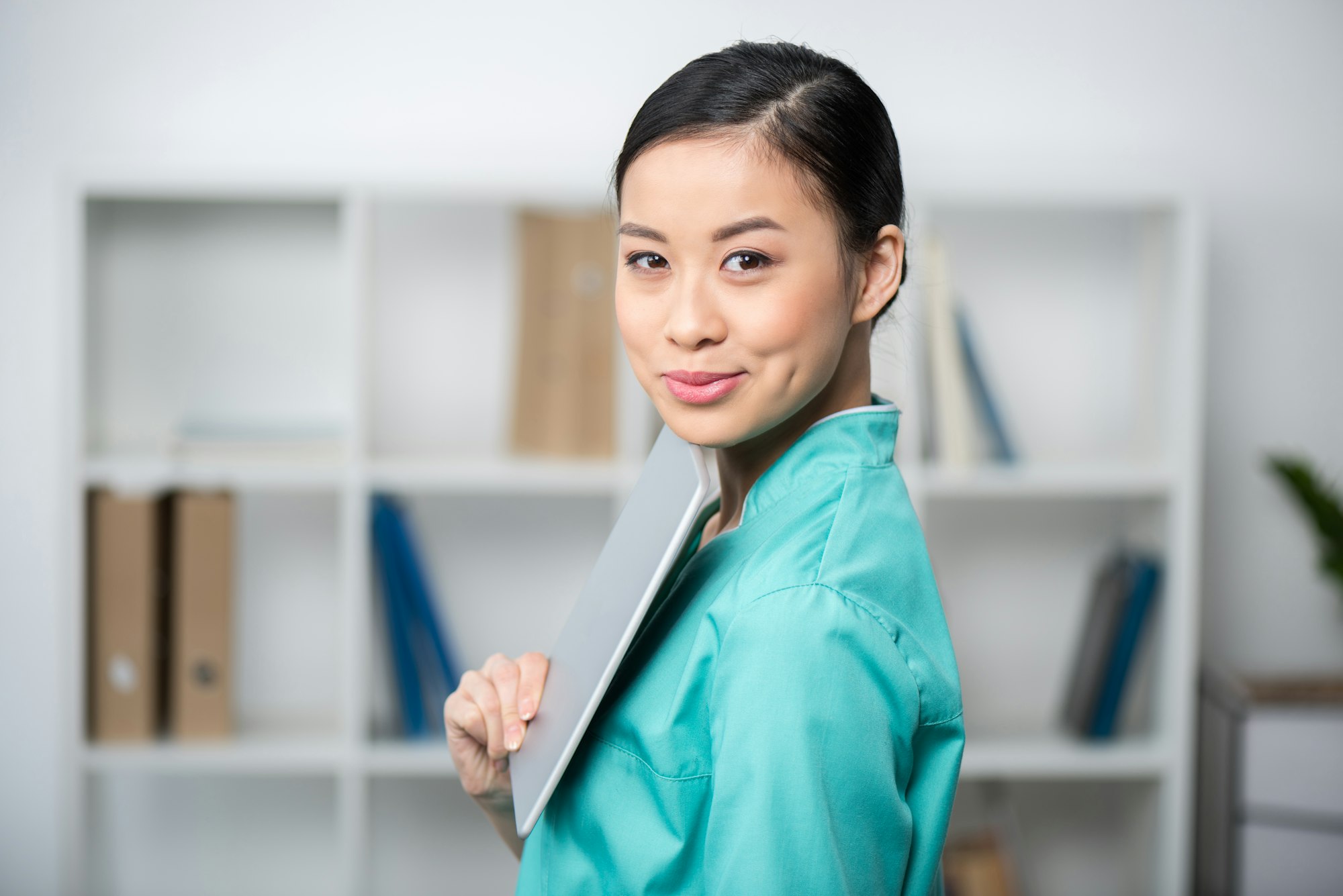 happy asian internist using digital tablet in professional clinic