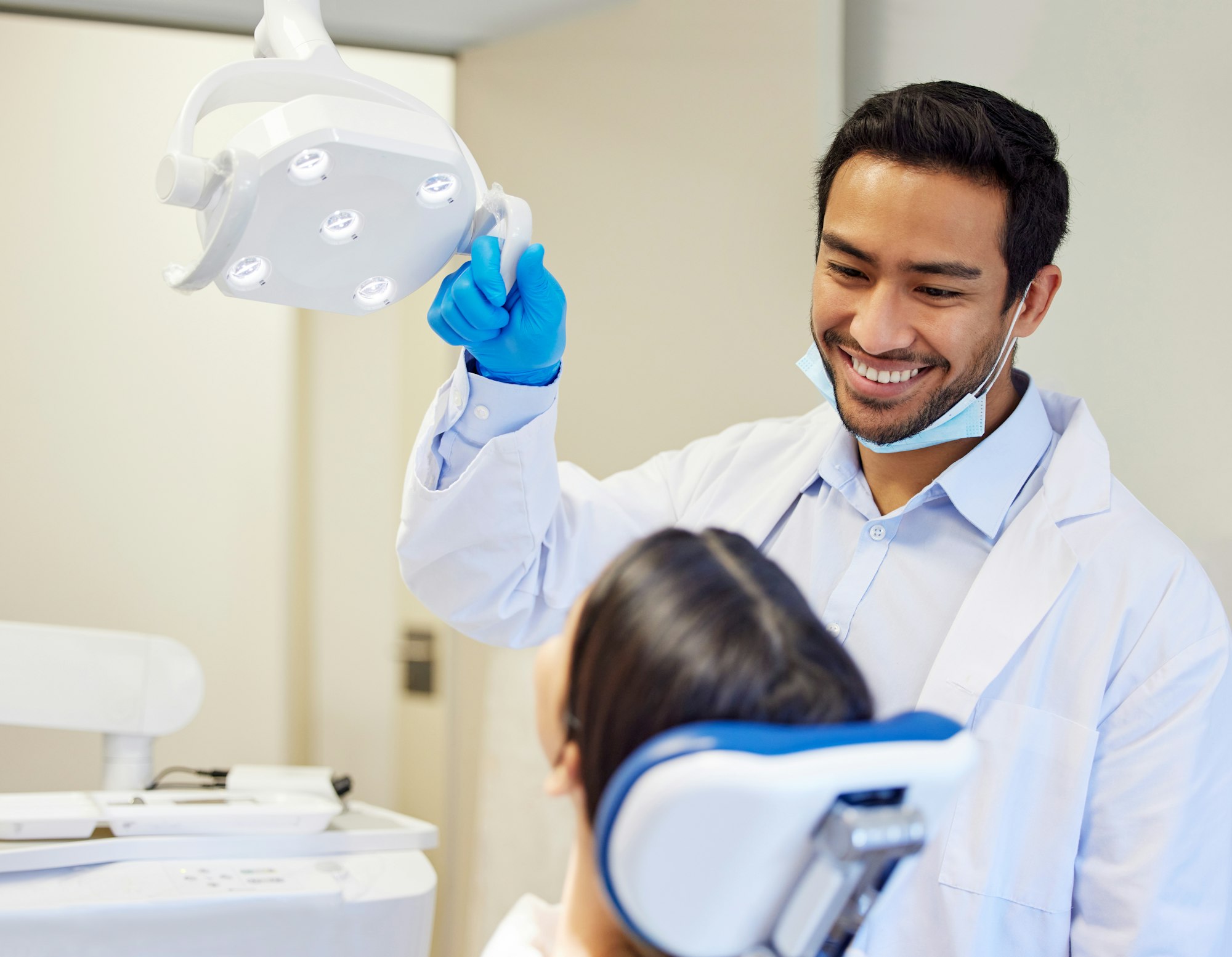 Shot of a young dentist getting ready to conduct a procedure on his patient