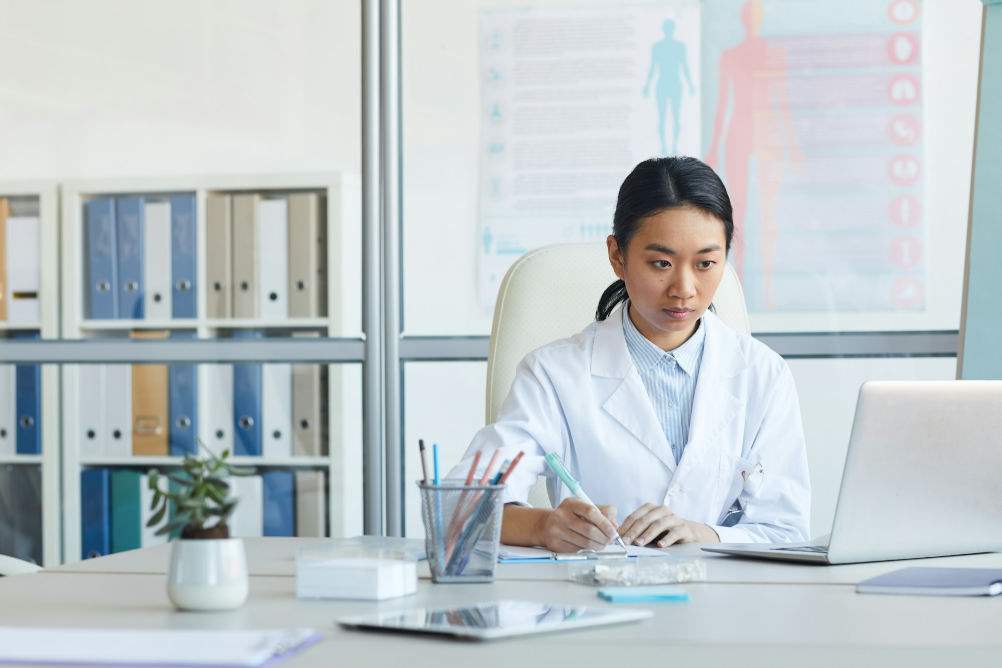 Young Female Doctor Using Computer